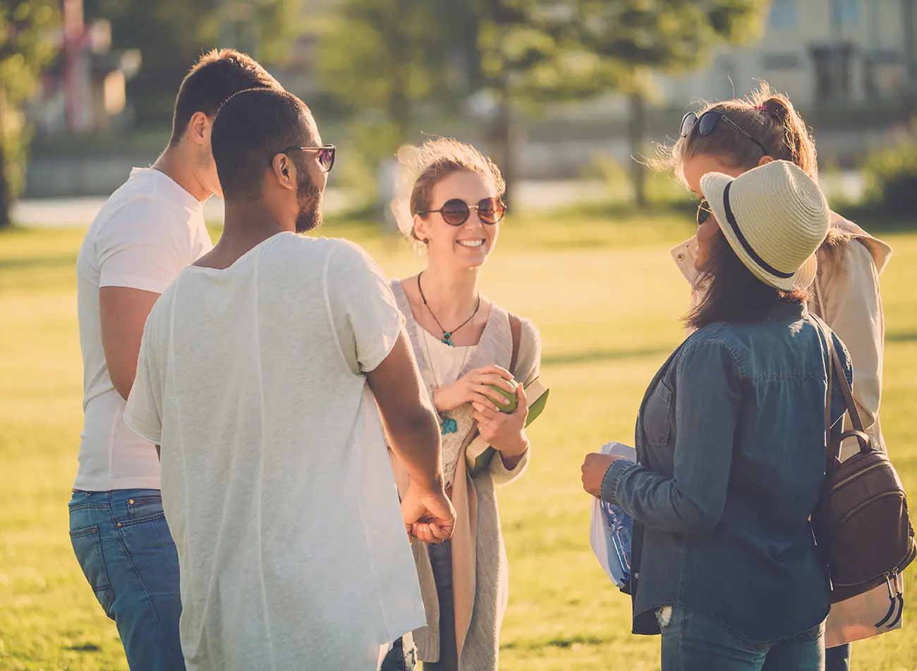 multi-ethnic-group-of-friends-chatting-in-a-park-2024-10-18-05-32-47-utc